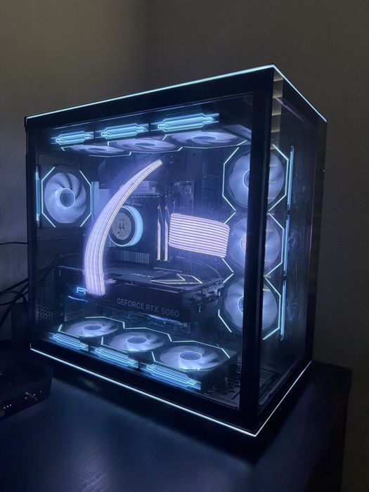 RTX 5080 showcase build in a dual-chamber glass case with cyan lighting